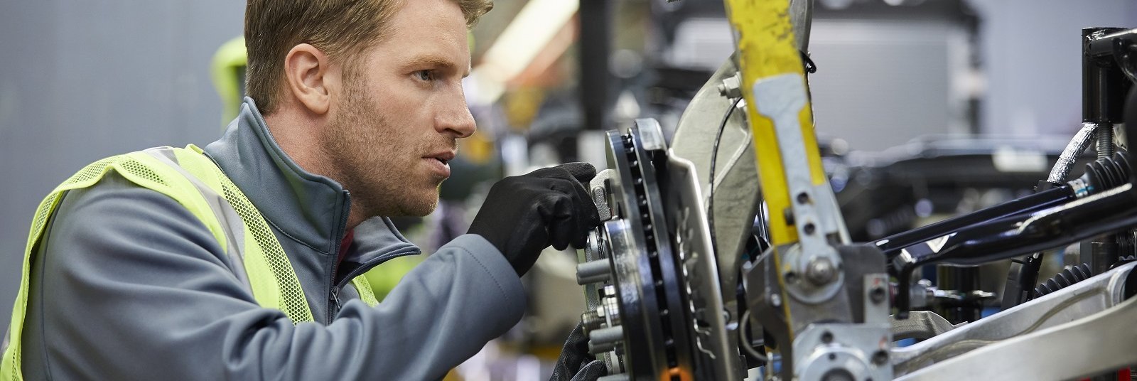 Ingenieur prüft Autoteil in Produktionshalle